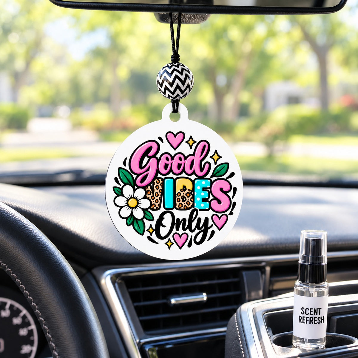 Good Vibes Only car freshie hanging in a car